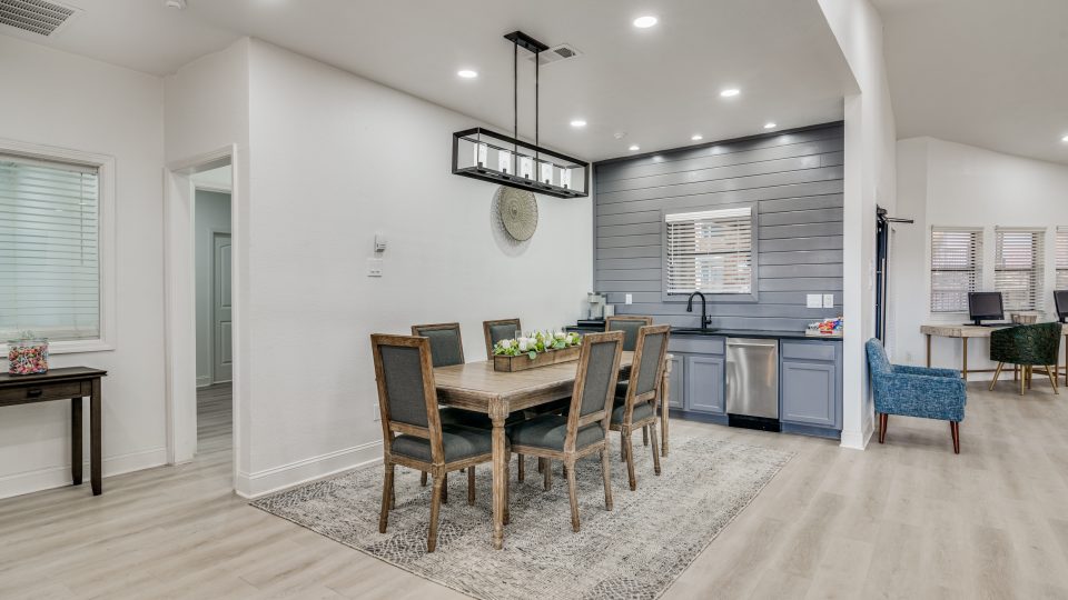 a kitchen and dining room with hardwood floors at The Falltree Apartments